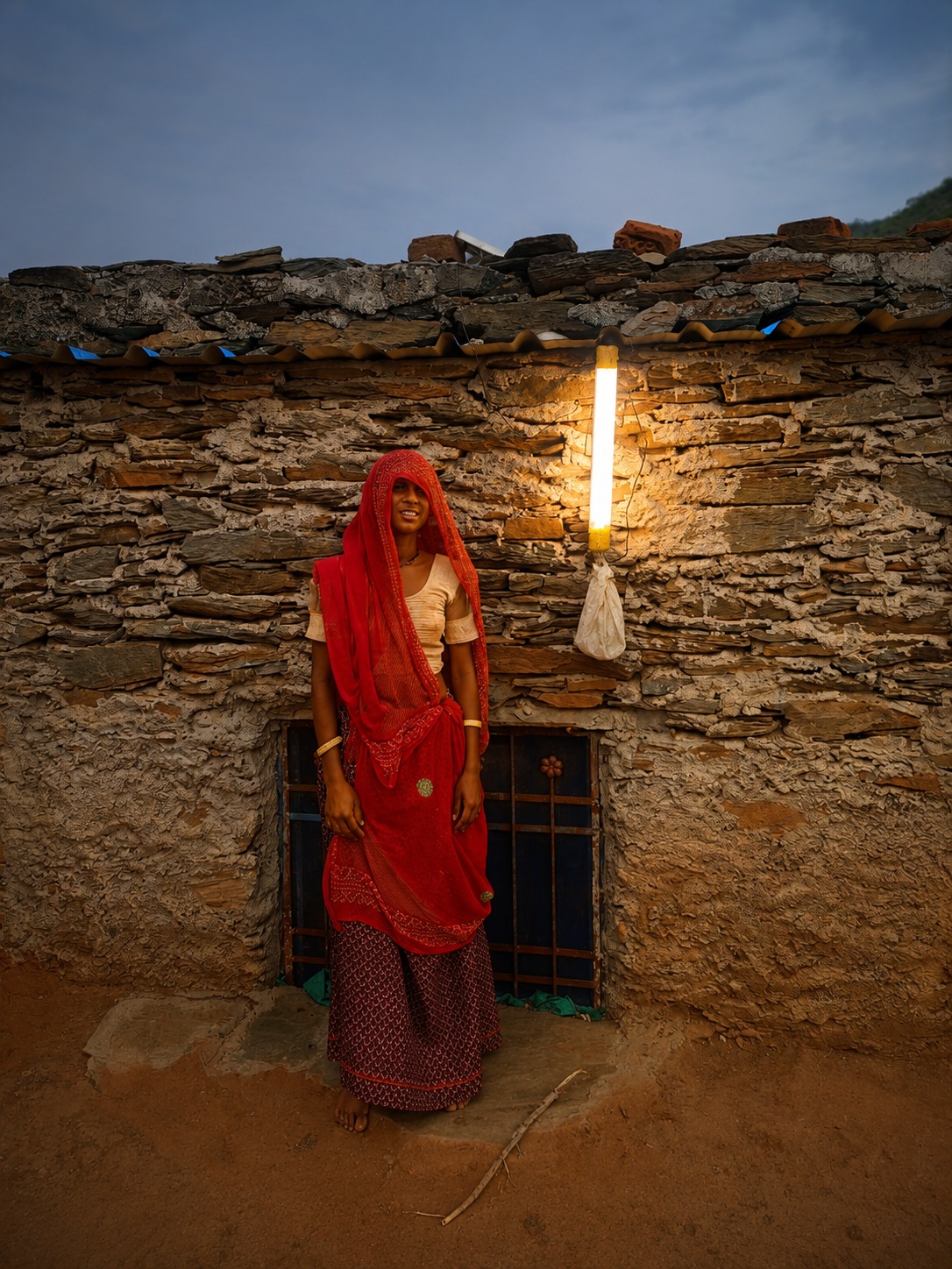 Beneficiary holding solar light at home